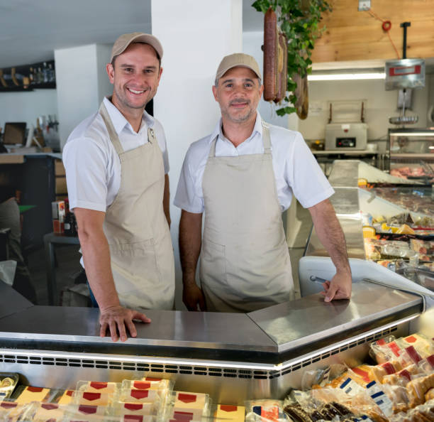 istock Happy men working at a delicatessen 950499344