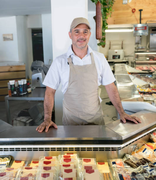 istock Happy man working at a delicatessen 950499372