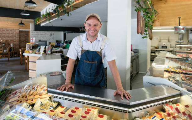 istock Happy man working at a delicatessen 950499402