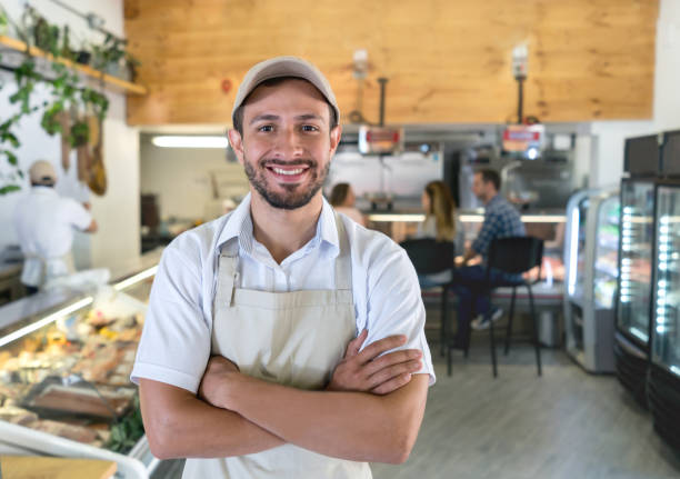 istock Happy man working at a delicatessen 950499424