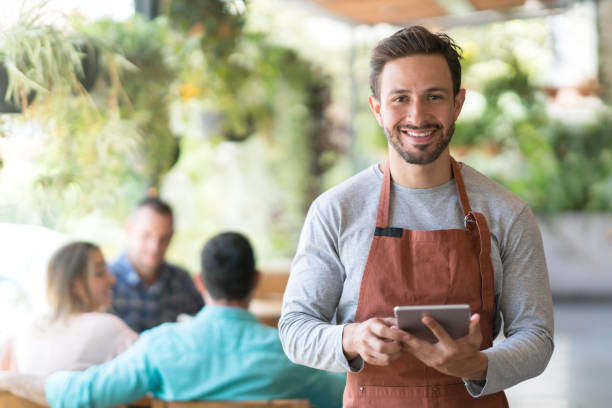 istock Happy waiter working at a restaurant 950499484