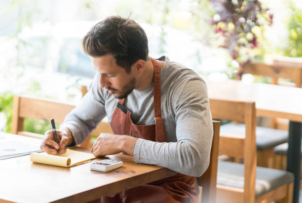 istock Waiter doing the books at a restaurant 950499494