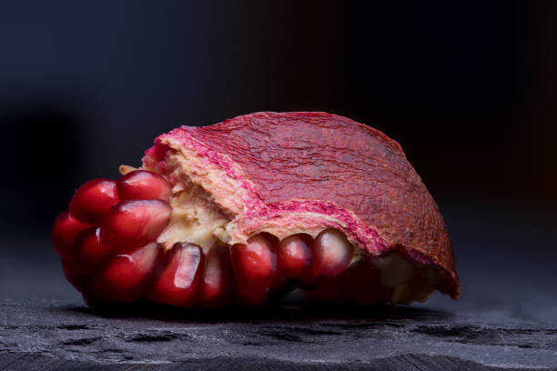 istock Open pomegranate on the slate platter 950499870