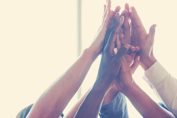 istock Group of workers high fiving. Multi ethnic and multi cultural group 950506074