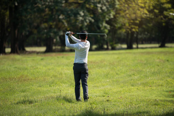 istock Golfers asia man show hit sweeping at green lawn 950511218