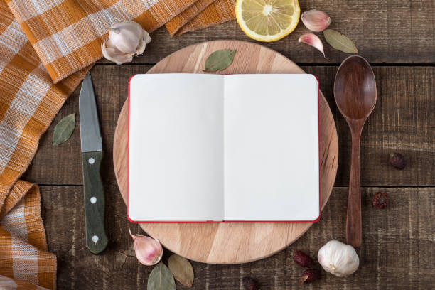 istock Recipe book with space for writing on a cutting wooden Board 950519128