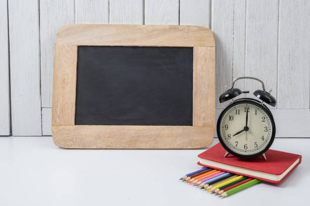 istock education workspace background concepts alarm clock, Color Pencil and Chalkboard with White wooden vintage wall 950522466