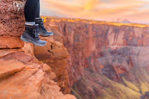 Stock photo of the gorgeous Horeshoe bend in Page Arizona at Sunrise with an active young hiker.