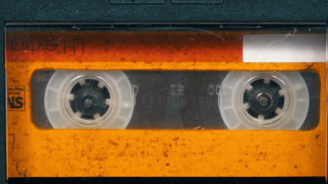 The Vintage Yellow Audio Cassette in the Tape Recorder Rotates