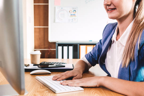 istock Businesswoman working with computer and typing text on keyboard at modern office 950554088