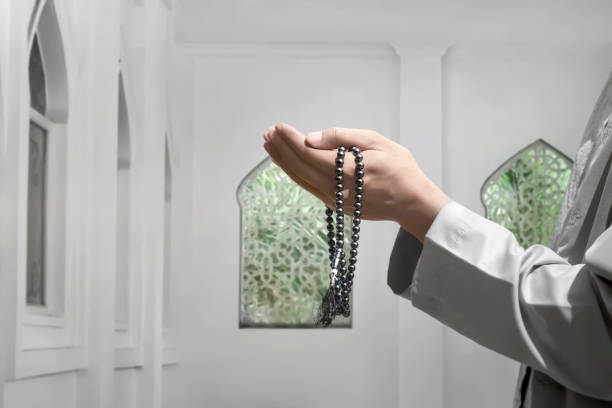istock Muslim man raising hand and praying to god 950556068
