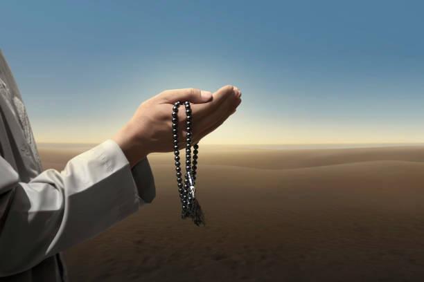 istock Muslim man pray with prayer beads 950556104