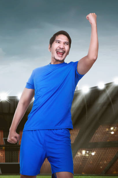 istock Young asian soccer player with excited expression 950558518