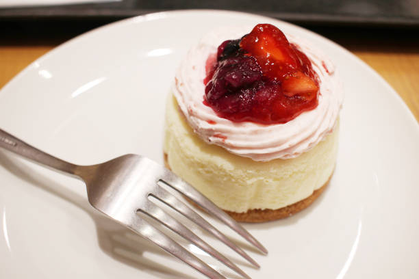 istock a Cheese cake with wild berries on white plate 950558714