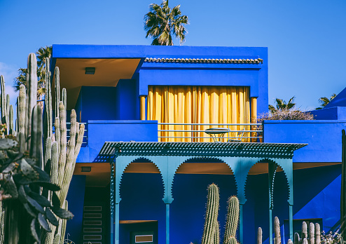 Marrakech,Morocco , 26th March 2018:Jardin Majorelle or Majorelle Garden is a botanical garden and artist's landscape garden in Marrakech, Morocco. It was created by French Orientalist artist, Jacques Majorelle. In the 1980s, the property was purchased by fashion designers, Yves Saint-Laurent and Pierre Berge who worked to restore it. Today the villa houses the Islamic Art Museum of Marrakech and the Berber Museum.