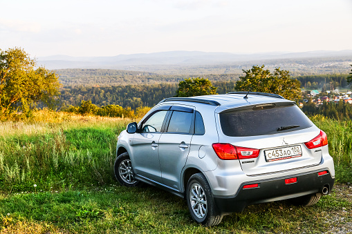 Vals, Switzerland - July, 22nd - 2022: Subaru SUV standing on a meadow, mountains in background