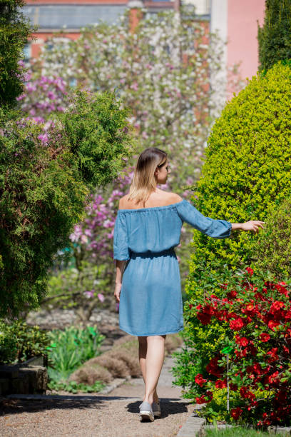 istock girl in springtime blossom garden. 950560530