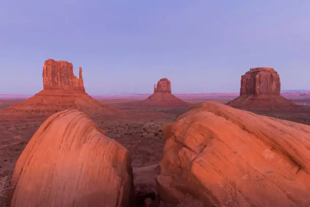 Long exposure on Valley Drive in Monument Valley showing the Mittens and cars travelling at the close of the park.