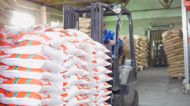 istock Red loaders transport pallet with boxes on industrial warehouse 950569218