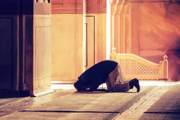 Photo of The muslim prayer for god in the mosque.