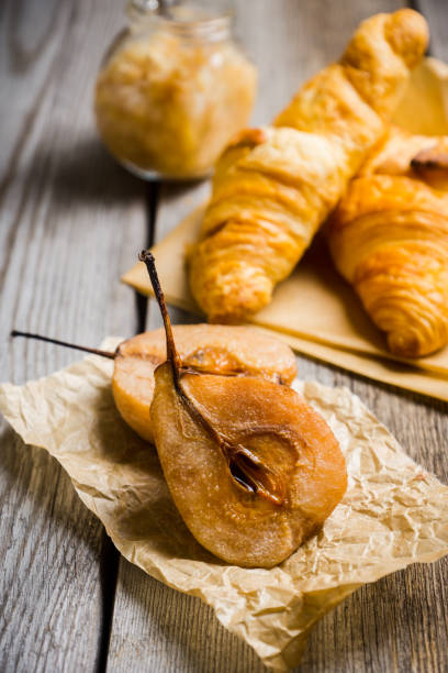 istock Fresh croissants and grilled pears with honey 950577686