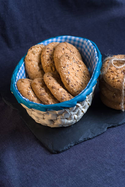 istock Savory cookies sprinkled with sesame seeds, sunflower on shale board 950578094