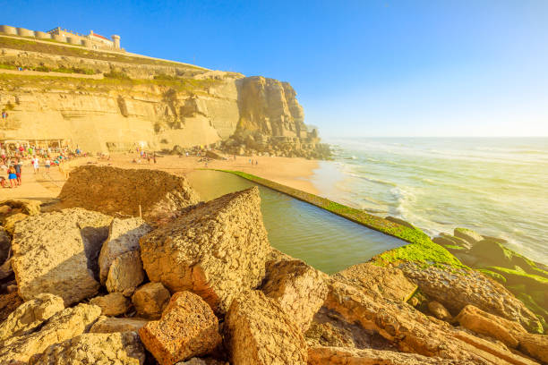 Pool of Azenhas do Mar Scenic promontory and beach at sunlight of Azenhas do Mar with famous natural pool visible at low tide on Atlantic Ocean in Portugal. Popular Portuguese seaside resort near Colares and Sintra. azenhas do mar stock pictures, royalty-free photos & images