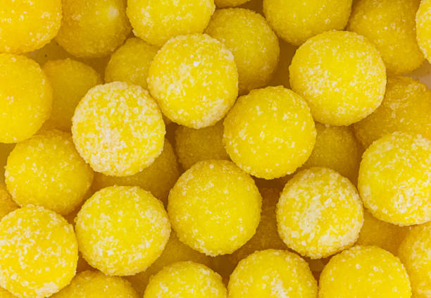 istock bright yellow round candy sprinkled with sugar grains background sunny festive 950583540