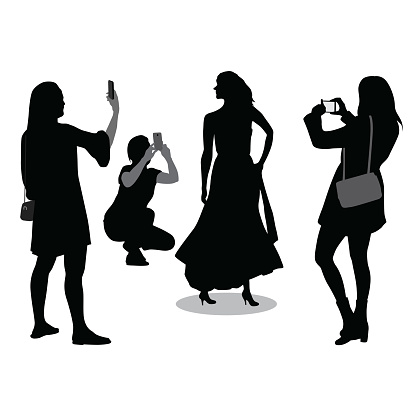 Fashion model with people taking her picture with their cellphones