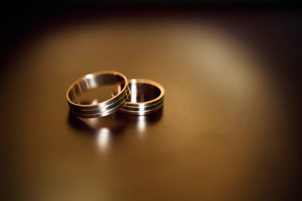istock Gold wedding rings lie on a wooden table 950586316
