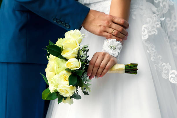 istock The bride is holding a wedding bouquet in her hands in nature 950587752