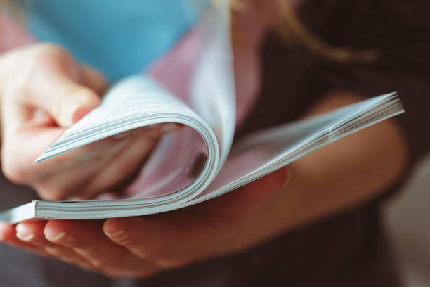 Close up view a stack of second hand magazines with yellow covers photographed with intentional artistic shallow depth of field