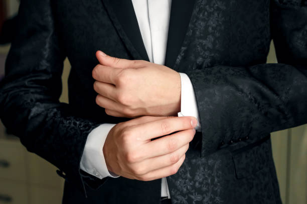 istock A man in a blue suit straightens his sleeves 950593102