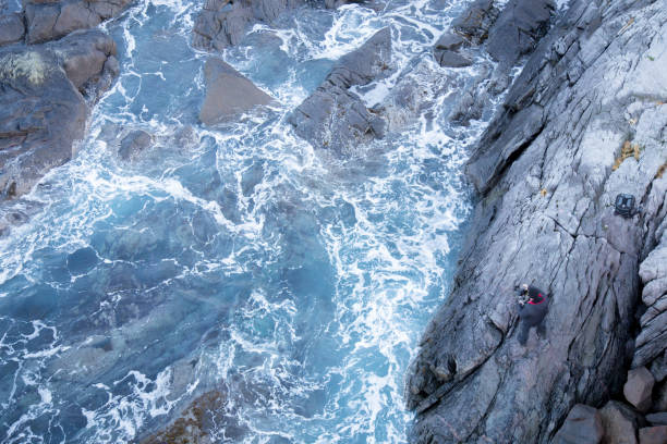istock Photographer taking a picture on a rocky coast 950593510
