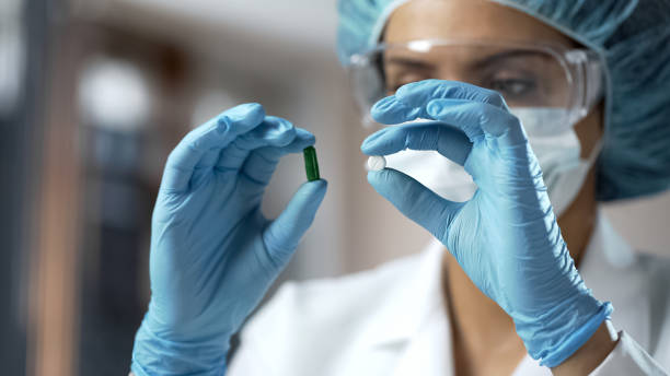 istock Pharmacology expert comparing two pills, analyzing medical research results 950594538