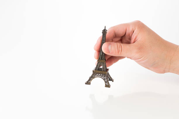 Eiffel Tower miniature with male hand