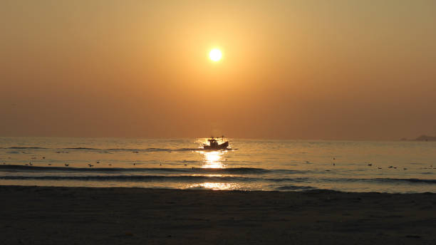istock Fishing boat departing at sunrise 950597238