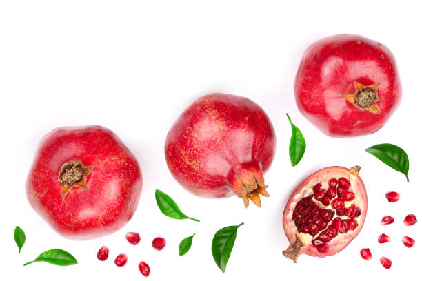 istock pomegranate with leaves isolated on white background with copy space for your text. Top view. Flat lay pattern 950597354