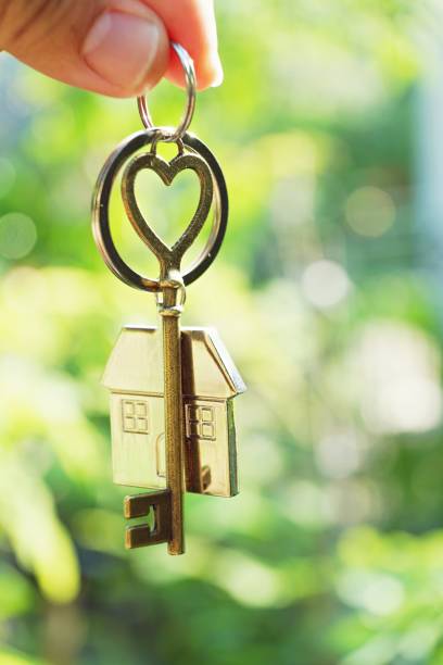 home key with love house keyring hanging with blur garden background, free space - garden key imagens e fotografias de stock