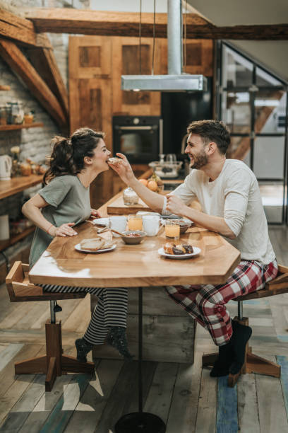 istock Young happy couple having fun during breakfast in the kitchen. 950597424
