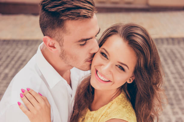 handsome young man kissing his beloved's cheek