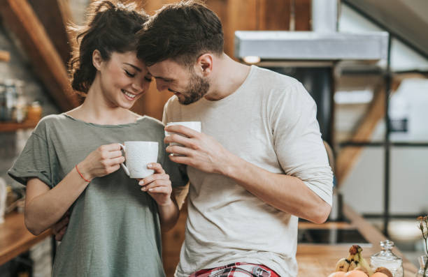 istock Happy couple in love flirting during coffee time at home. 950602112