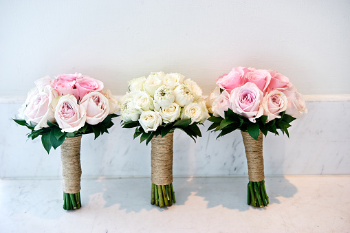 Pink roses and white cream roses wedding bouquet of the bride and bridesmaids