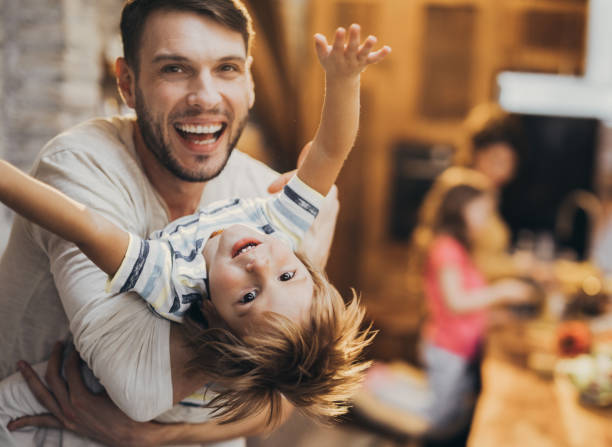 istock Happy boy having fun while his father is playing with him at home. 950602688