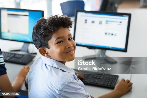 istock School boy using computer 950603046