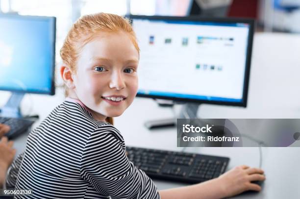 Pupil Girl Using Computer At School Stock Photo - Download Image Now - Child, Computer, School Building