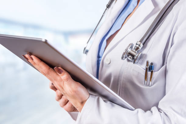 istock Woman doctor with tablet over blue pharmacy background 950603250