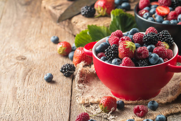 different berries in bowl. - fruta com grão imagens e fotografias de stock