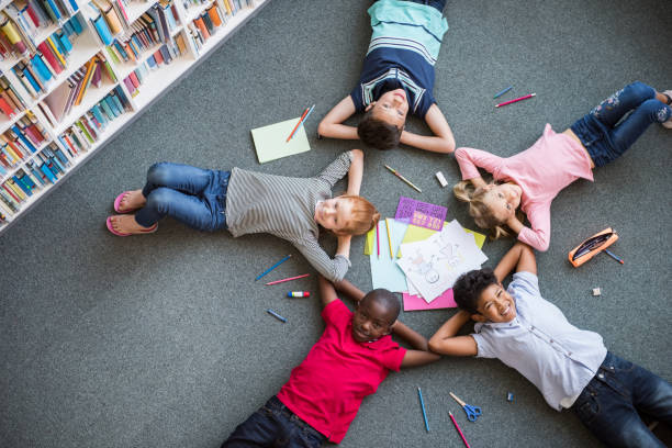 istock Happy children lying on floor 950603850