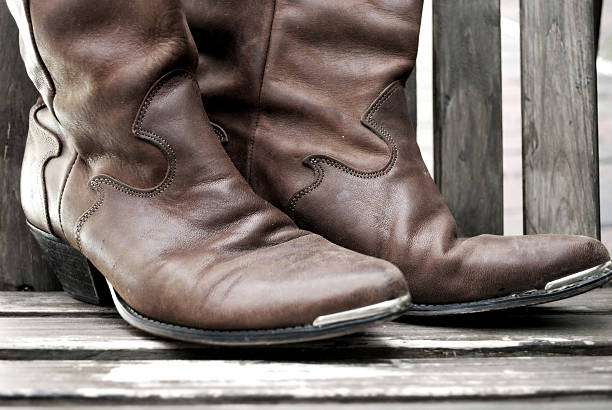 istock Muted Sepia Pair of Worn Western Cowboy Boots 95060438